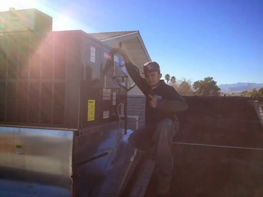 HVAC technician performing Boiler Repair on a rooftop unit in Springboro